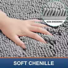 Gray soft chenille rug with hand touching it, labeled 'Non-Shedding' and 'Soft Chenille'.