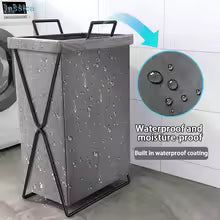 Gray laundry basket with waterproof coating feature on a tiled floor.