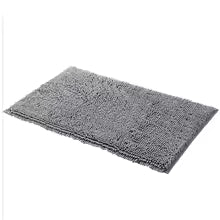 Gray rectangular bath mat with a soft, plush texture on a white background.